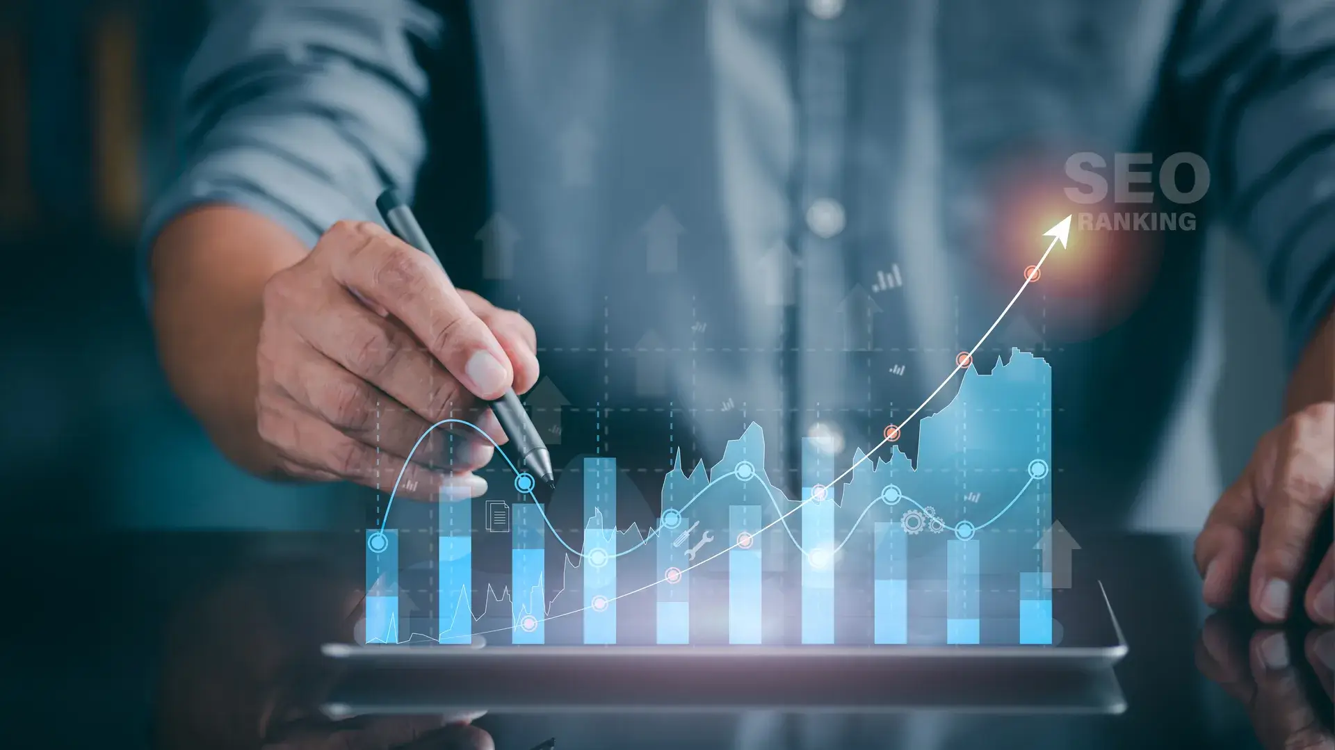 A marketer holds a pen pointing to a graph and shows SEO concepts